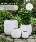 The Tapered Series alabaster white cone-shape planters on a modern patio
