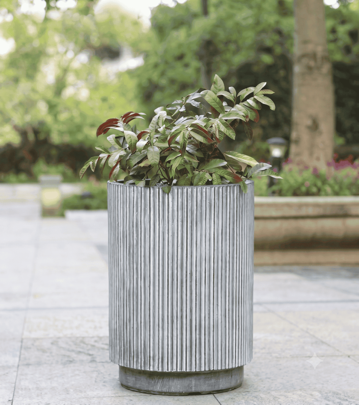 Durable fluted column planter pots styled elegantly on a bright patio deck