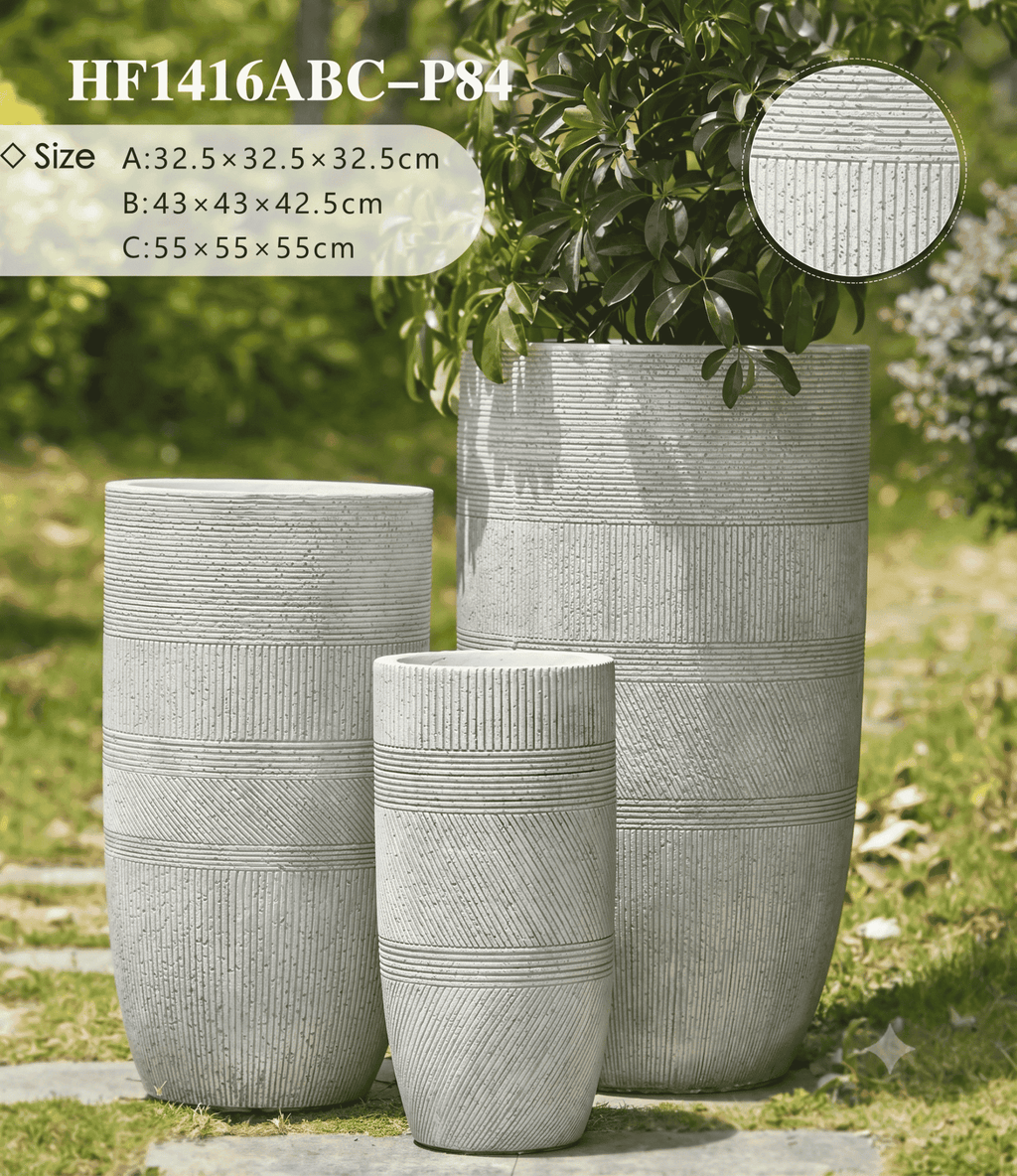 Three gray textured planters of different sizes on a grassy background