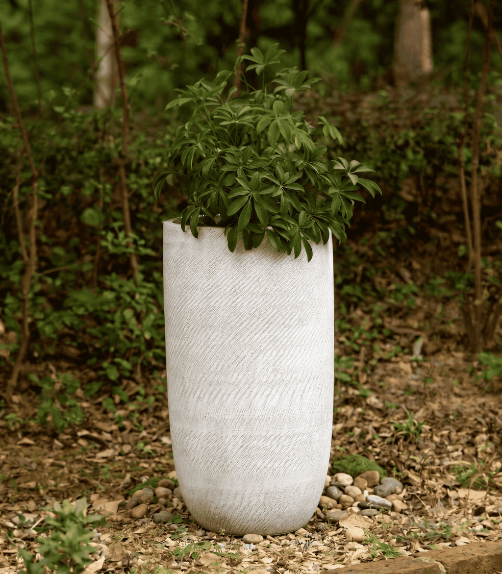 Close-up view of textured pebble-grain U-shape planter pots designed for contemporary plant styling