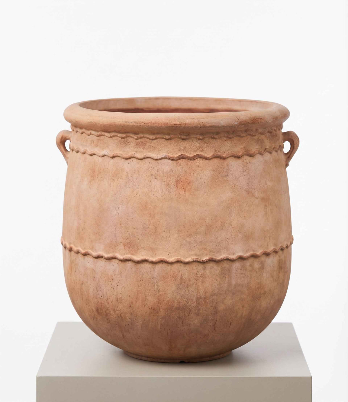 Close-up view of classic ribbed earth planters styled for indoor and outdoor garden spaces